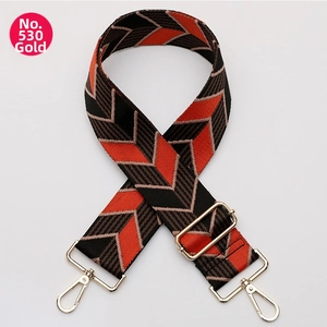 Macro shot of No. 530 gold metal hooks and V-pattern adjustable woven bag strap