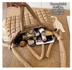 Spacious interior of quilted puffer tote bag showing capacity for daily essentials