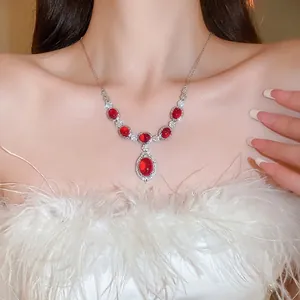 Luxurious silver necklace with red drop-shaped gemstone and white cubic zirconia accents
