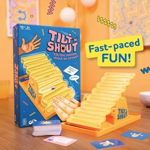 Detail of Tilt 'N Shout puzzle game showing the yellow seesaw, cards, and packaging box