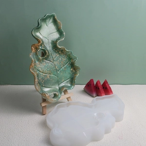 Macro detail of leaf-shaped resin mold with finished glittery green leaf tray display