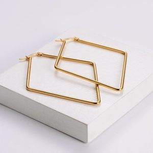 Minimalist gold titanium steel square hoop earrings on a white minimalist display