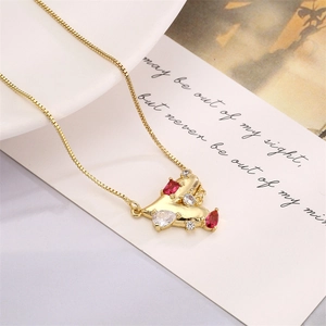 Detail of gold box chain necklace with heart pendant featuring red and white zircon stones