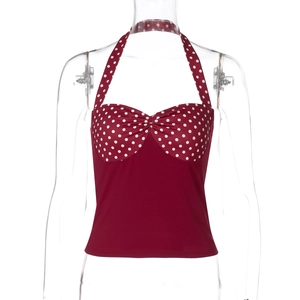Detail view of red polka dot halter top with tie-neck design on transparent mannequin