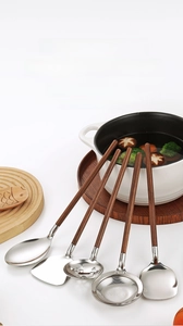 Detail of 304 stainless steel kitchen tool set with premium walnut wood handles