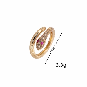 Detailed view of gold snake-shaped open ring with white and red zircon inlay details