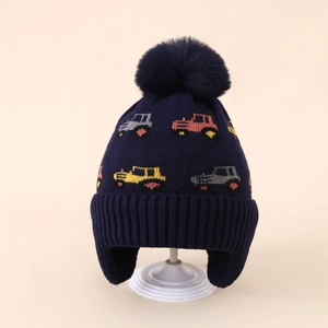 Detail view of navy blue knit earflap hat for boys featuring colorful tractor patterns