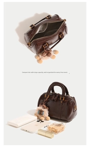 Deep brown Boston bag detail showing internal storage capacity and plush lamb charm accessory