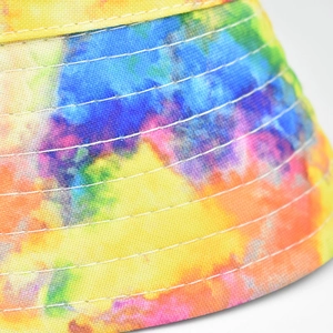 Macro shot of colorful tie-dye bucket hat fabric with reinforced white stitching detail