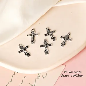 Macro shot of a vintage cross pendant with religious relief on a ceramic plate