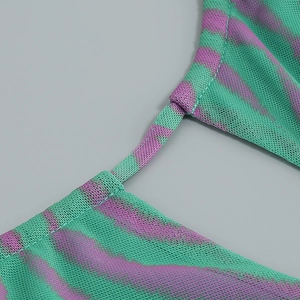 Close-up of mesh fabric showing green and purple zebra print with reinforced stitching