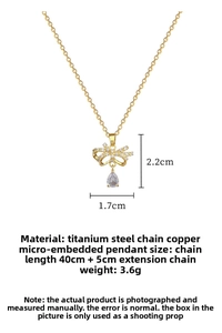 Detail of gold butterfly necklace with pave crystals and pear-shaped drop stone