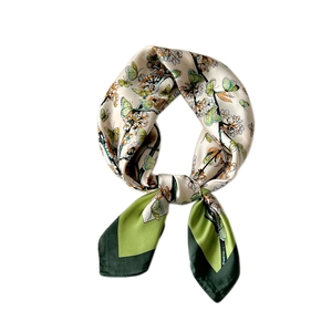 Green and white floral silk scarf featuring butterfly patterns and elegant satin luster