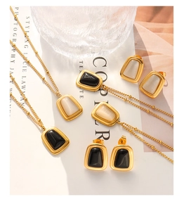 Detailed view of cat's eye stone jewelry sets on a magazine with soft shadows