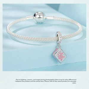 Macro detail of S925 silver mesh bracelet with Mahjong charm and zircon stones