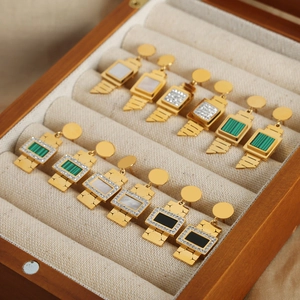 Elegant gold watch-inspired earrings with malachite, pearl, and zircon in a jewelry box