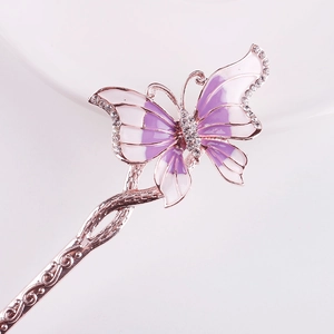 Detail of rose gold butterfly hairpin with purple enamel and sparkling crystal accents