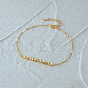 Detail of a gold-plated S925 silver bracelet featuring a row of sparkling cubic zirconia