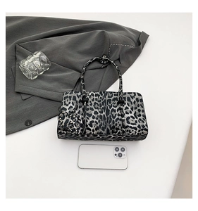 Detail of leopard print handbag with heart charm and phone for size reference