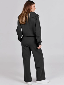 Rear view of black casual two-piece tracksuit with wide-leg pants and hooded sweatshirt