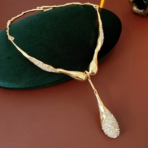Détail du collier en Y doré avec strass goutte d'eau sur support en velours
