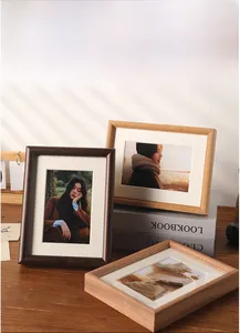 Detailed view of thick solid wood picture frames in walnut and natural oak finishes