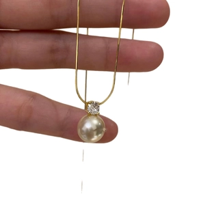 Minimalist gold stainless steel necklace featuring a pearl and zircon pendant on a thin chain