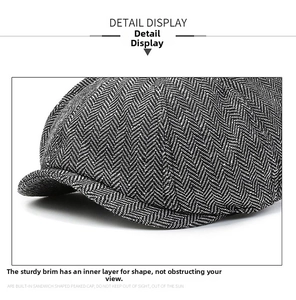 Close-up of dark grey herringbone beret with built-in brim support for a clear view