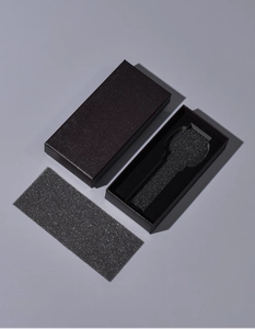 Detail view of rectangular watch gift box with leather texture and black foam insert