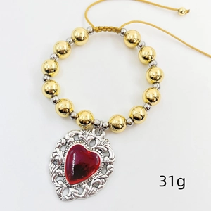 Detail of red enamel heart charm bracelet with copper beads weighing 31g on white background