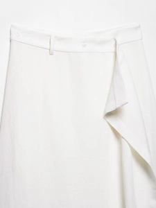 Detail of white linen blend skirt featuring asymmetrical front fold and button closure