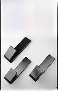 Three matte black adhesive metal hooks with U-shaped design for wall storage