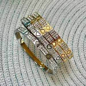 Double row crystal titanium steel bangle with heart and floral engraving in gold and silver