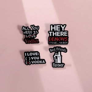 Set of four creative alloy pins with funny English slogans on a pink background