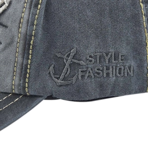Close-up of vintage washed grey cotton baseball cap with yellow stitching and embroidery