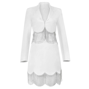 Detailed view of white blazer dress featuring elegant silver tassel fringes and lapels