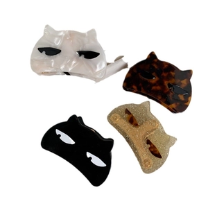 Cat-shaped acetate hair claws in white, tortoiseshell, black, and glitter gold colors