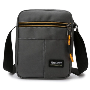 Men's gray oxford cloth crossbody bag with adjustable strap and yellow zipper detail