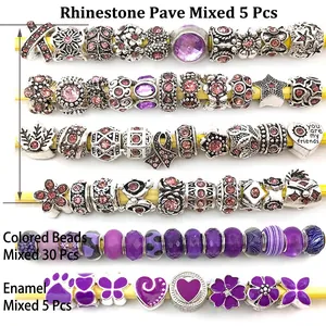 Macro view of silver alloy beads with purple crystals and patterned glass charms