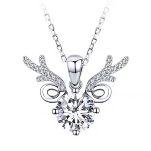 Close-up of silver elk antler pendant with a brilliant round-cut sparkling gemstone