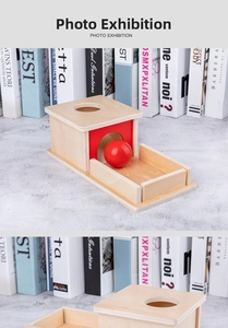Detail view of Montessori wooden object permanence box with red ball for early learning