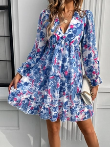 Close-up of floral print V-neck dress with ruffle sleeves and tiered hemline detailing