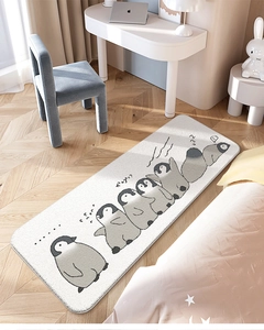 Close-up of fluffy penguin cartoon bedroom rug on wooden herringbone floor