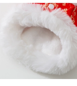 Detail of red festive pet vest with golden flower embroidery and thick white faux fur lining