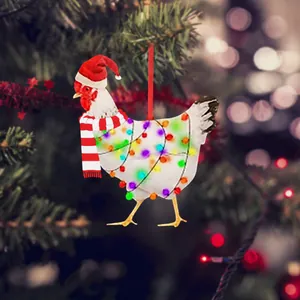 Detail of chicken Christmas ornament with scarf and hat on festive tree background