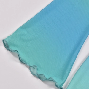 Detail of blue-green gradient mesh fabric with ruffle lettuce edge trim on summer set