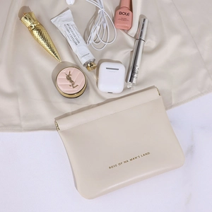 Elegant cream leather self-closing pouch for cosmetics and cables on soft silk