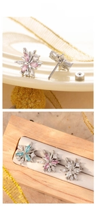 Detail of snowflake zircon earrings with screw back design in pink, blue, and white colors