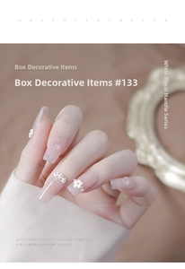 Close-up of 3D resin flowers and pearls on pink glitter nails with a vintage mirror frame
