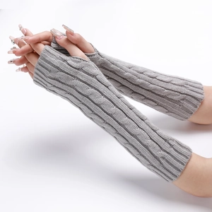 Detailed view of grey cable-knit arm warmers with thumb holes for winter comfort